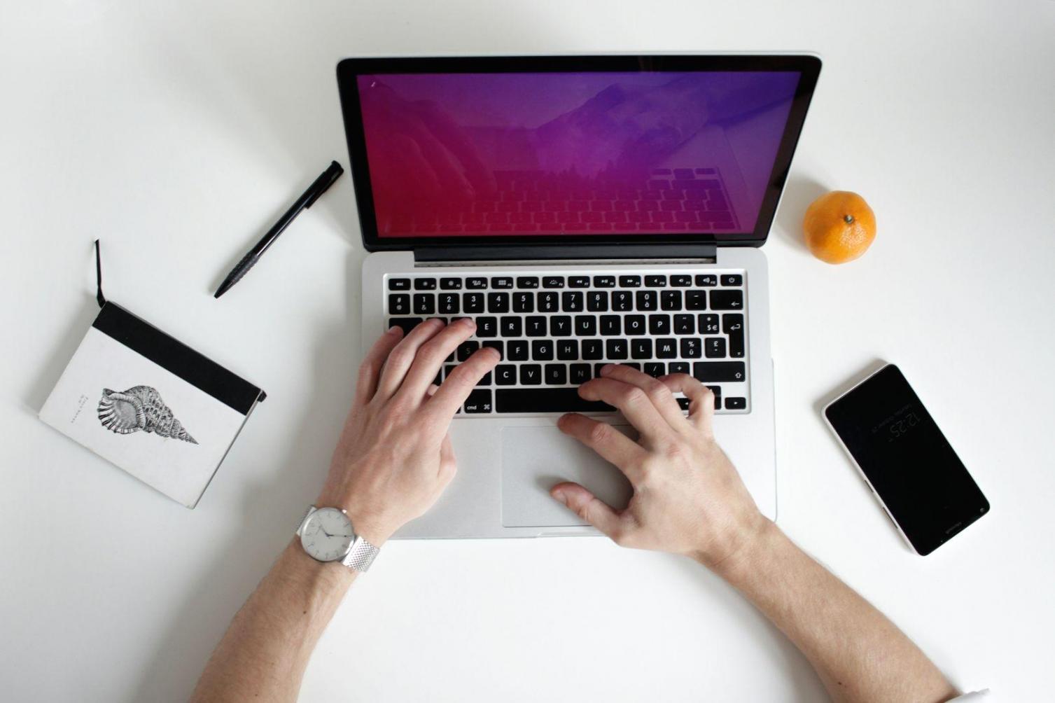Professional working through financial analysis on computer screen